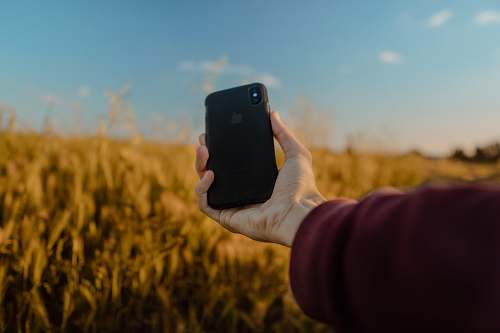 cell phone person holding space gray iPhone X mobile phone